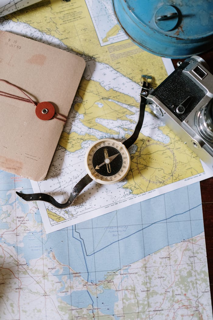 portfolio-03 Compass and camera on a vintage map flat lay, perfect for travel planning and navigation themes.